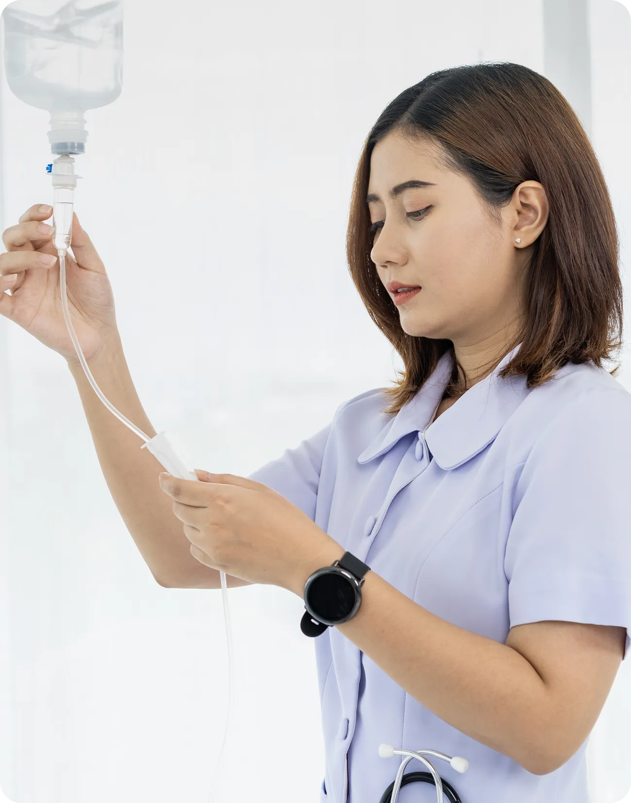 Safer Infusion Systems, Inc. Nurse adjusting IV drip in hospital.